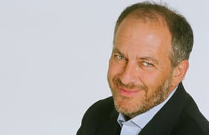 photo of a smiling man with a beard wearing a suit. It's David Strom!